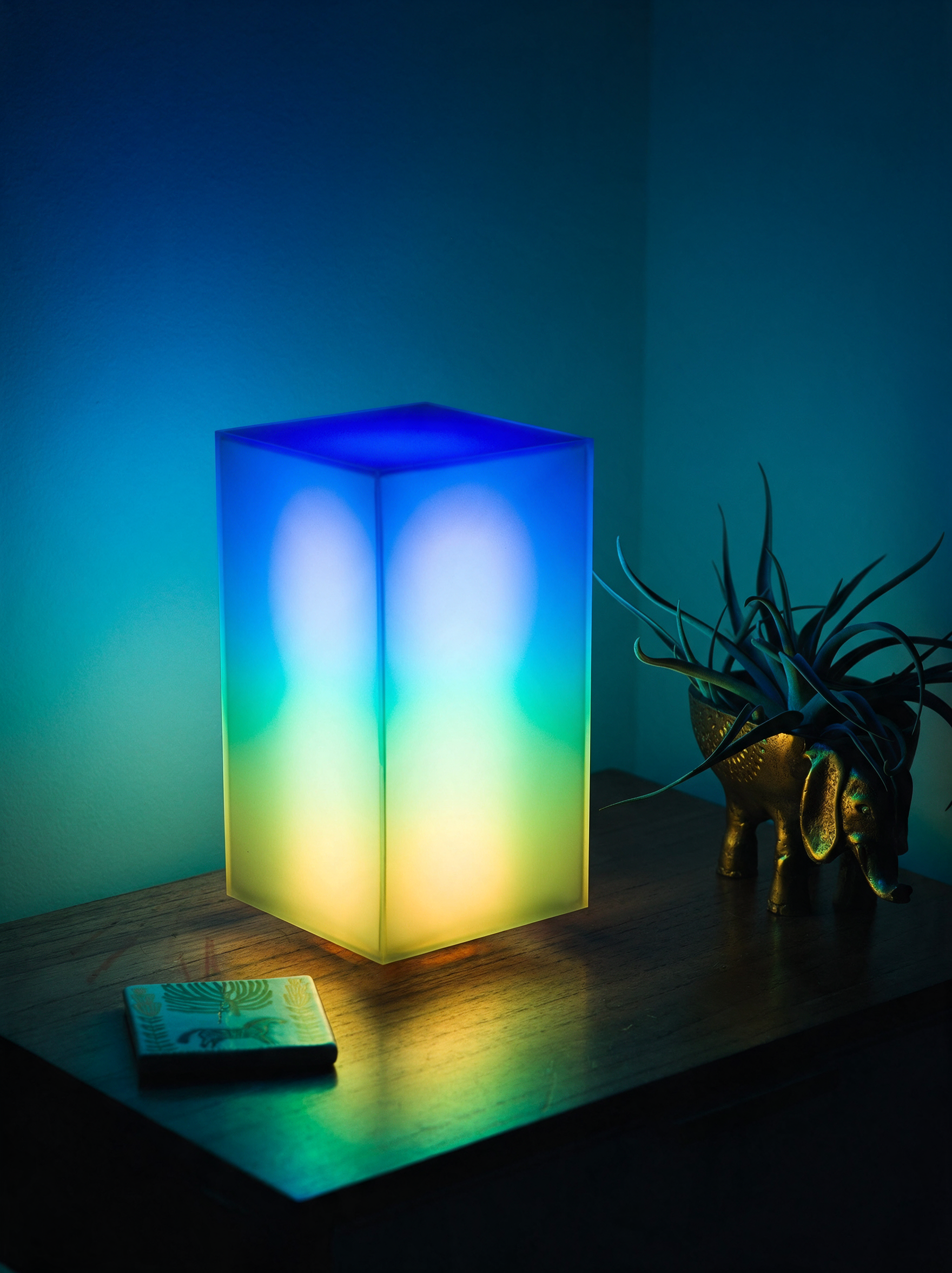 Lumen smart LED lamp glowing multicolour pattern in bedroom