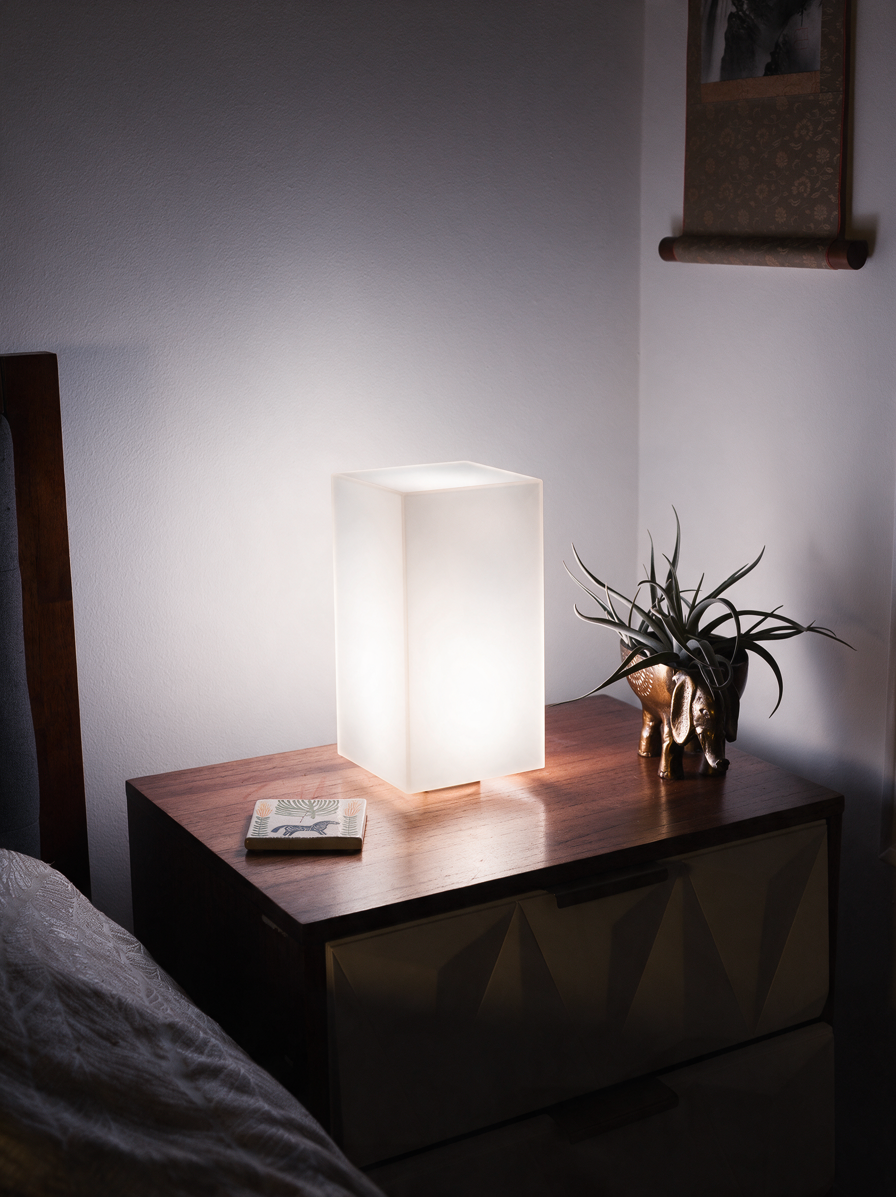Lumen smart LED lamp glowing soft white pattern in bedroom